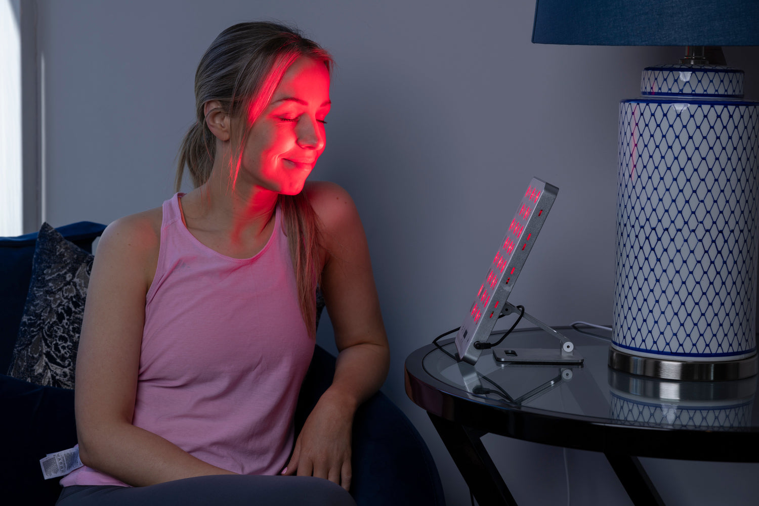 woman using red light therapy